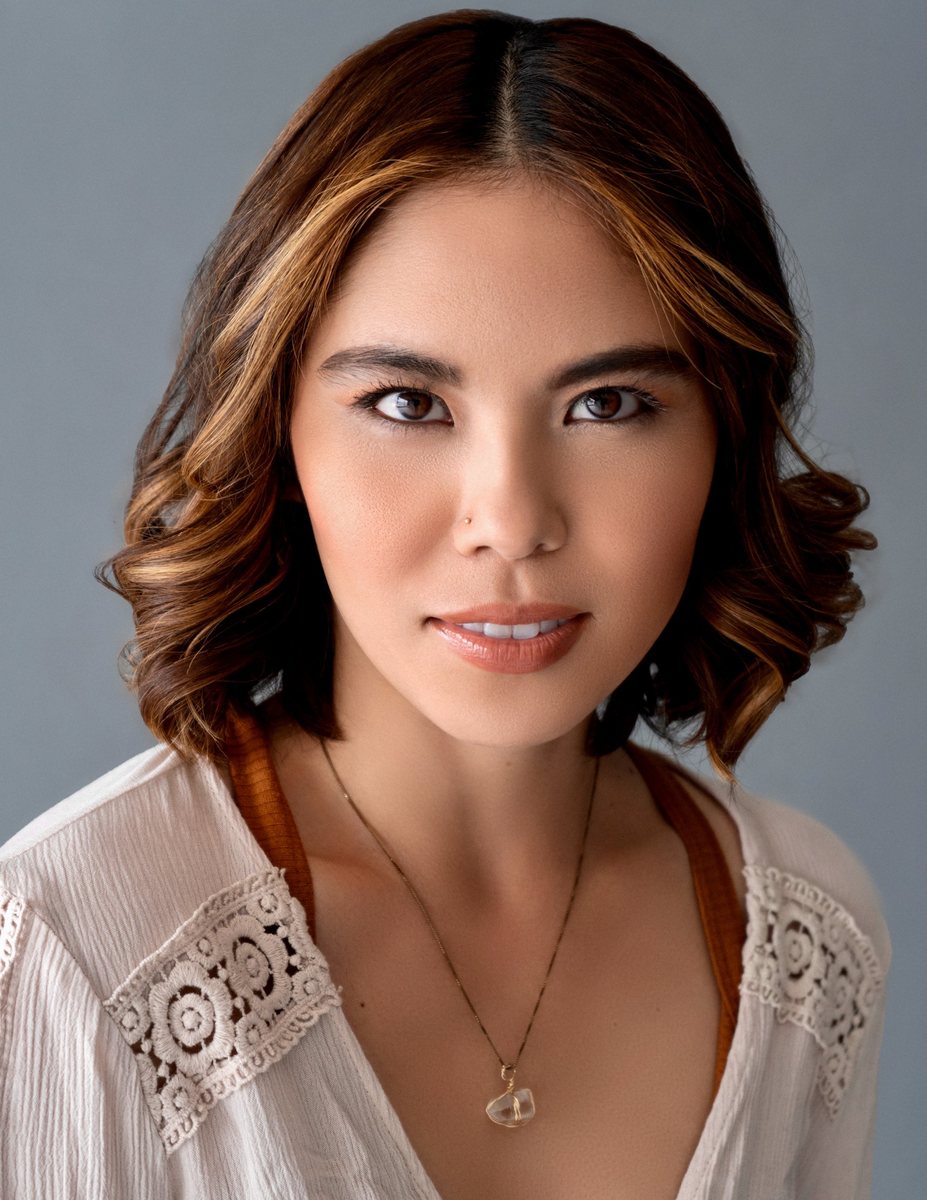 Actor headshot, woman with wavy hair in a lace blouse